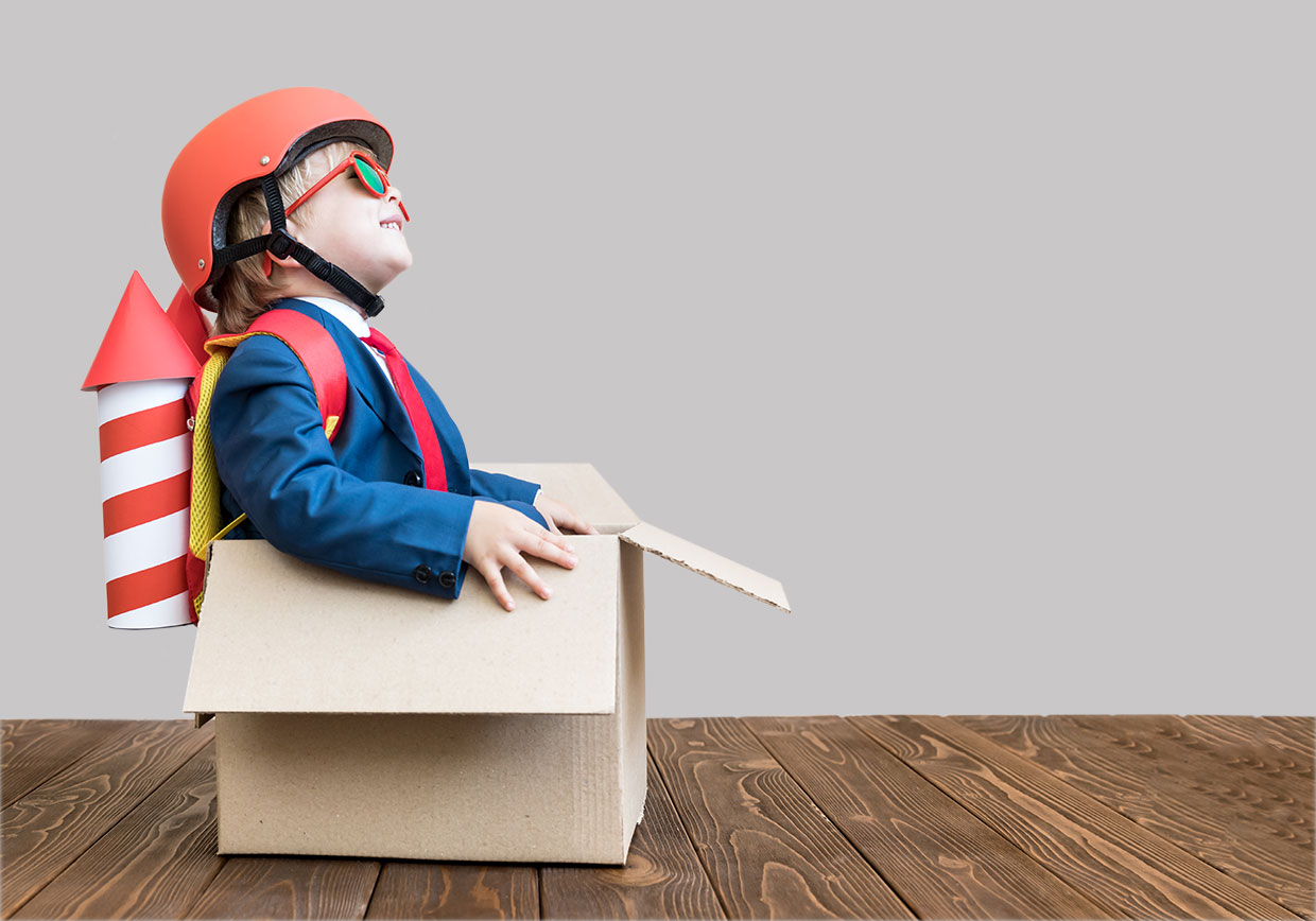 3PL Solutions from McCorquodale presented by a young child sat in a packing box. He has a rocket on his back, getting ready for take off. Store it, print it, pick it, pack it, ship it.